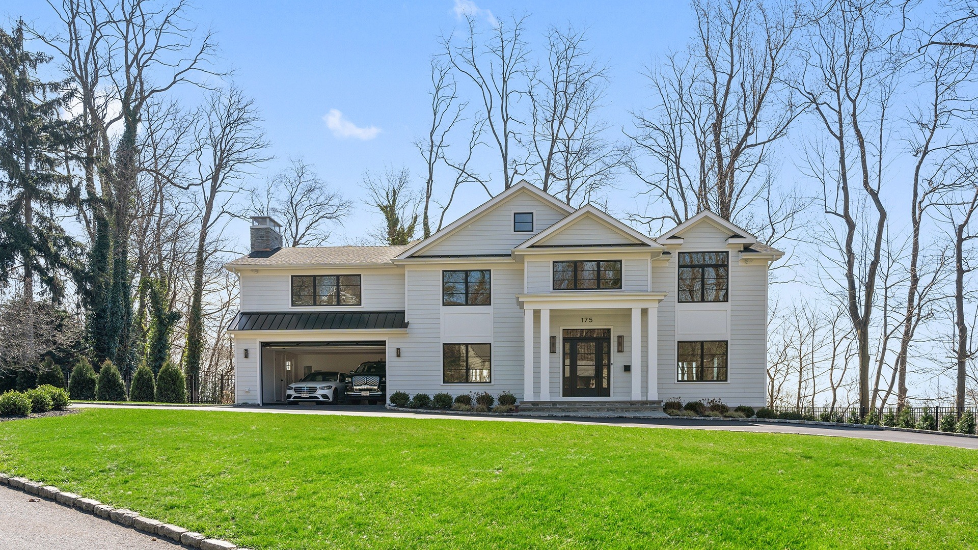 175 Peach Drive house photo a large white house with a garage and a lawn