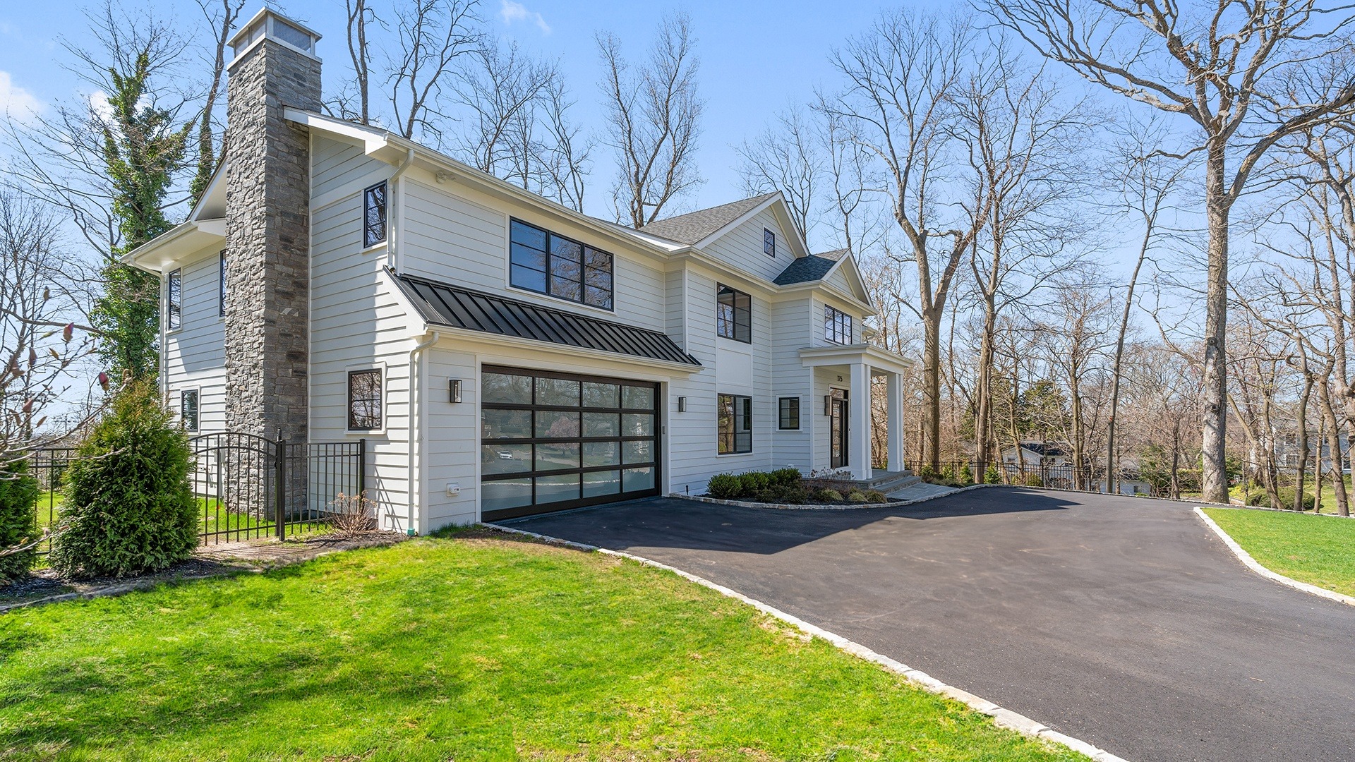 edited 88 a large white house with a driveway and trees in the background